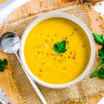 Authentic Lebanese lentil soup served in a white bowl, garnished with parsley.