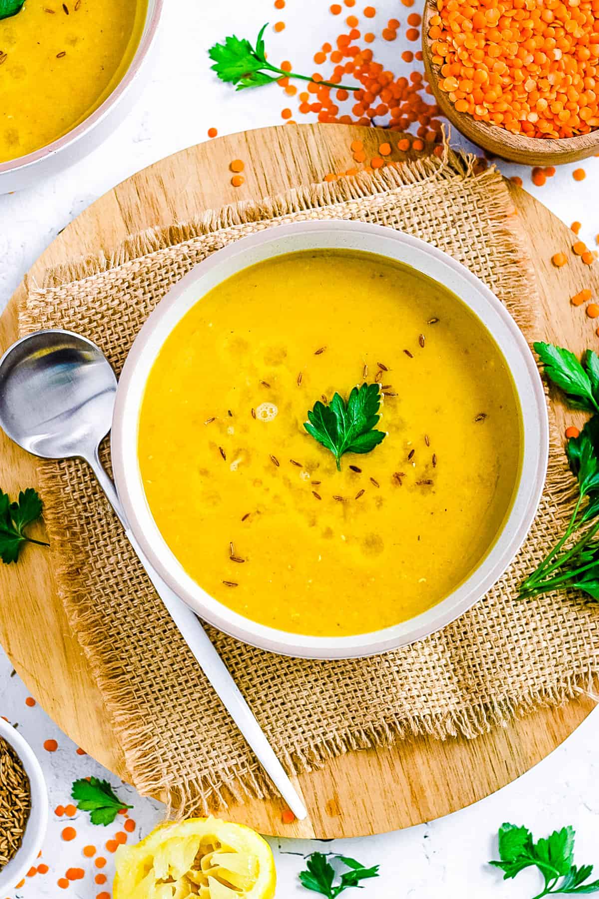 Authentic Lebanese lentil soup served in a white bowl, garnished with parsley.