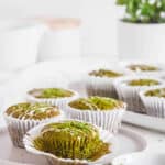 easy healthy matcha muffins recipe on a white plate with lemon frosting