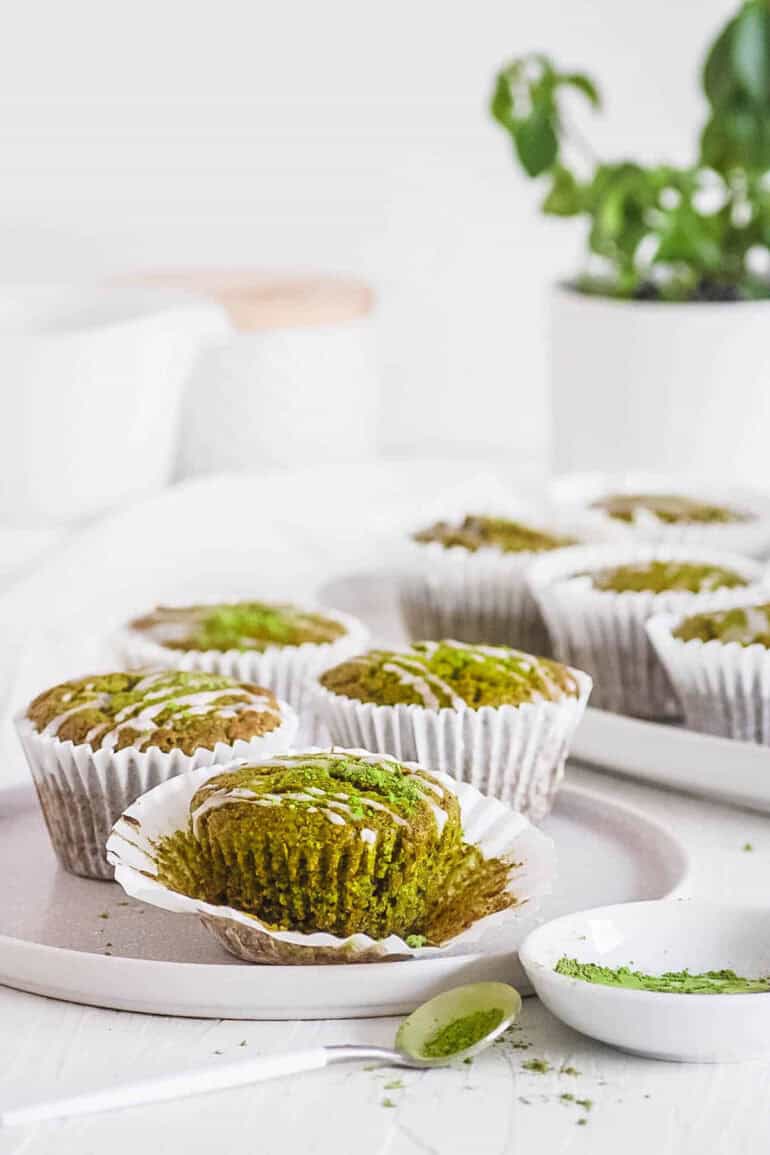 easy healthy matcha muffins recipe on a white plate with lemon frosting