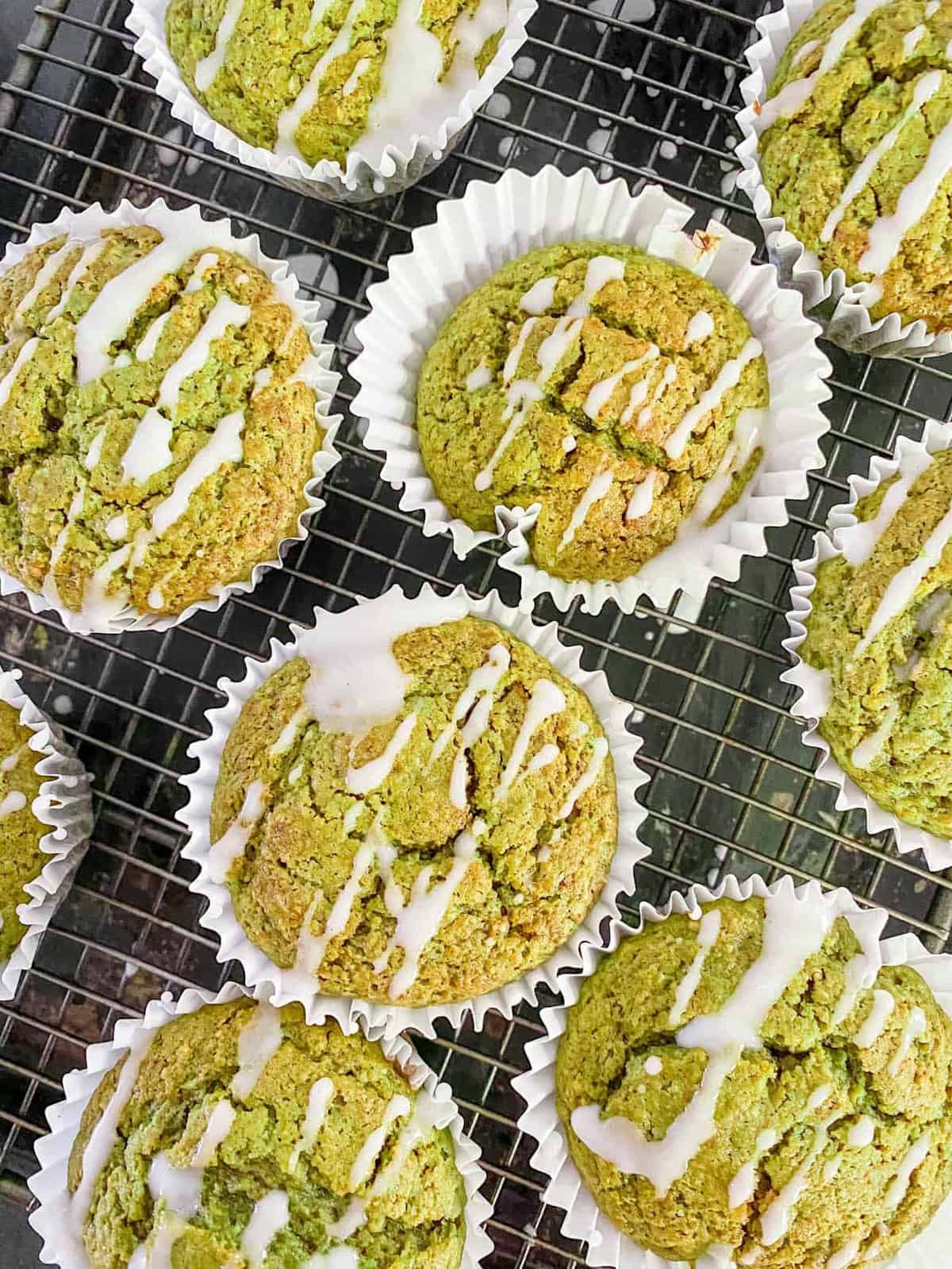 easy healthy matcha muffins recipe on a wire rack with lemon frosting