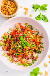 Meatless low carb vegetarian egg roll in a bowl, served in a white bowl, garnished with green onions.