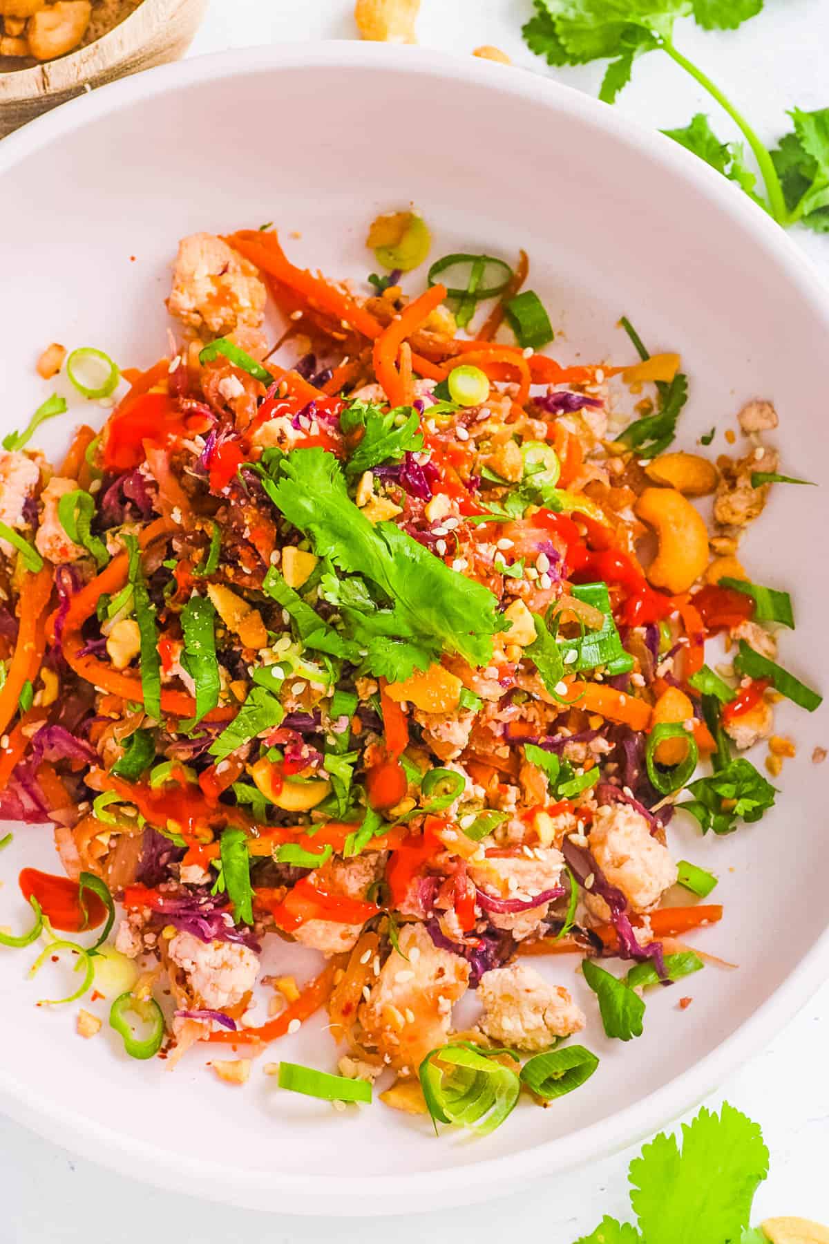 Easy healthy vegetarian egg roll in a bowl, served in a white bowl, garnished with green onions.