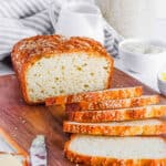 Healthy, low-calorie gluten free bread recipe, baked and sliced on a cutting board.