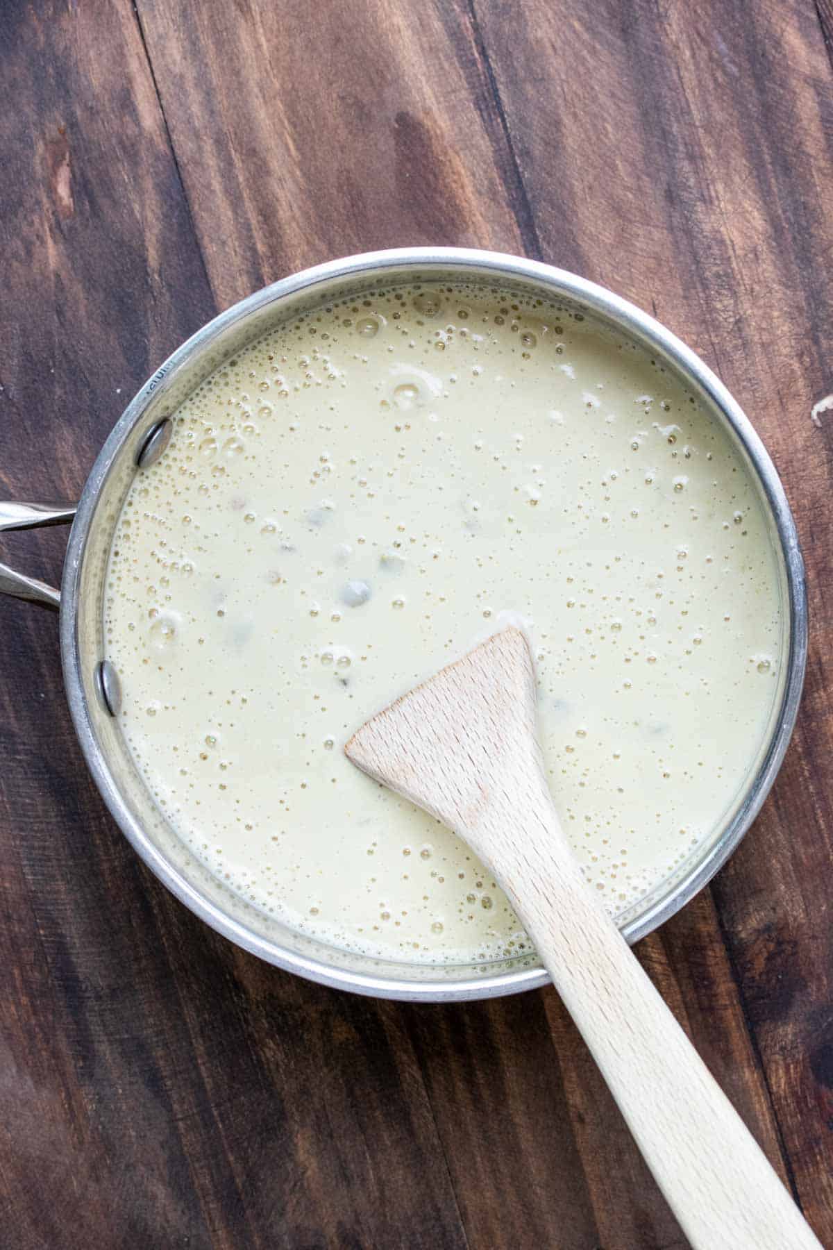 Top view of white Mexican cheese sauce cooking in pot