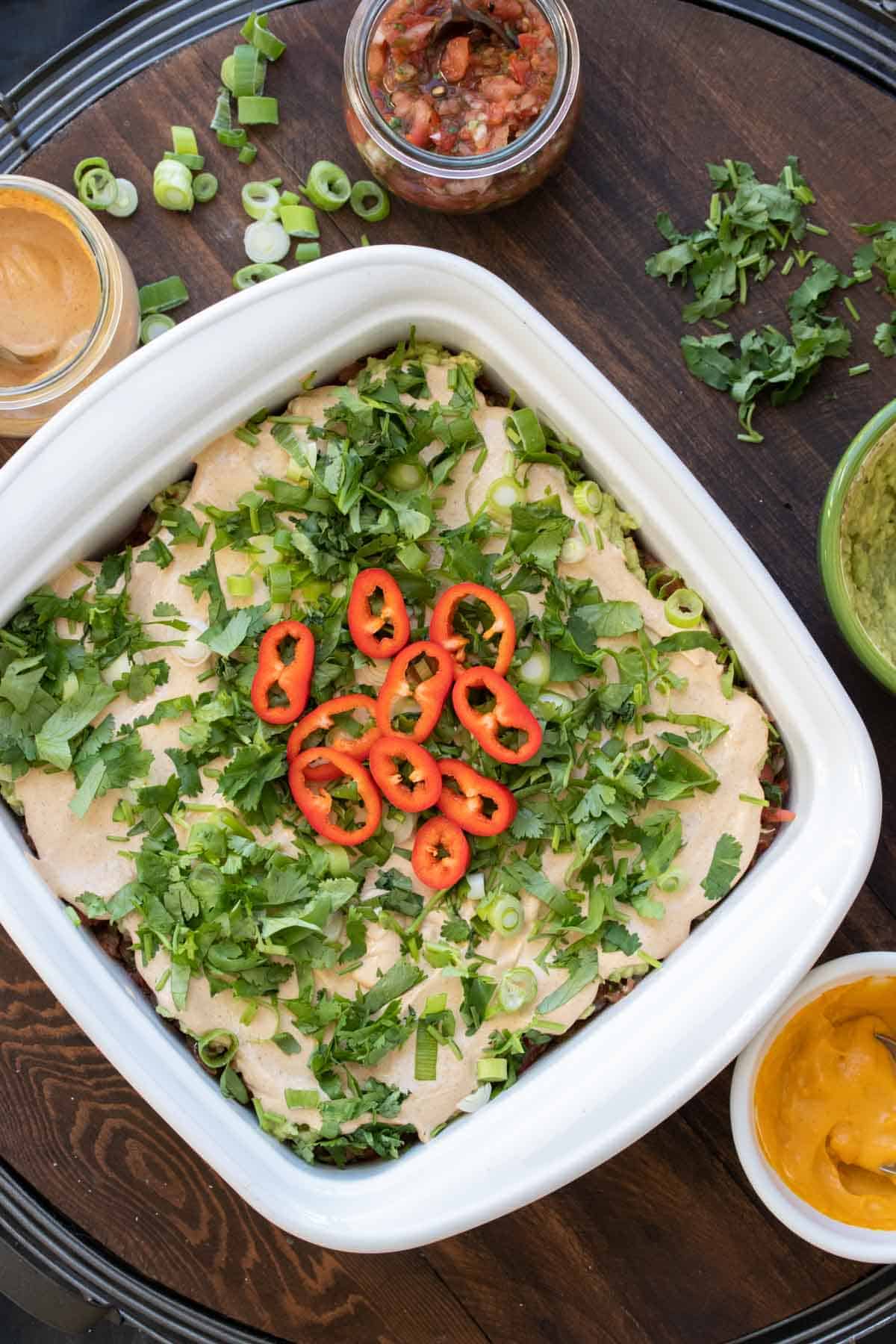 Top view of a 7 layer dip in a white baking dish.