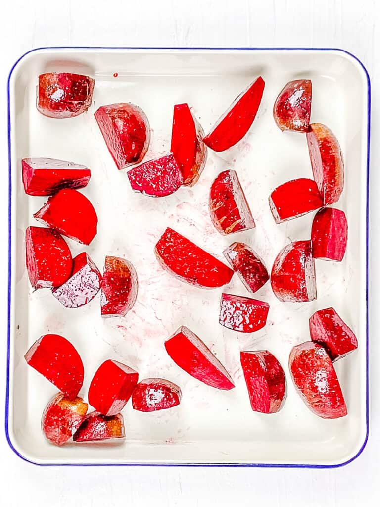 Roasted beets on a baking sheet.