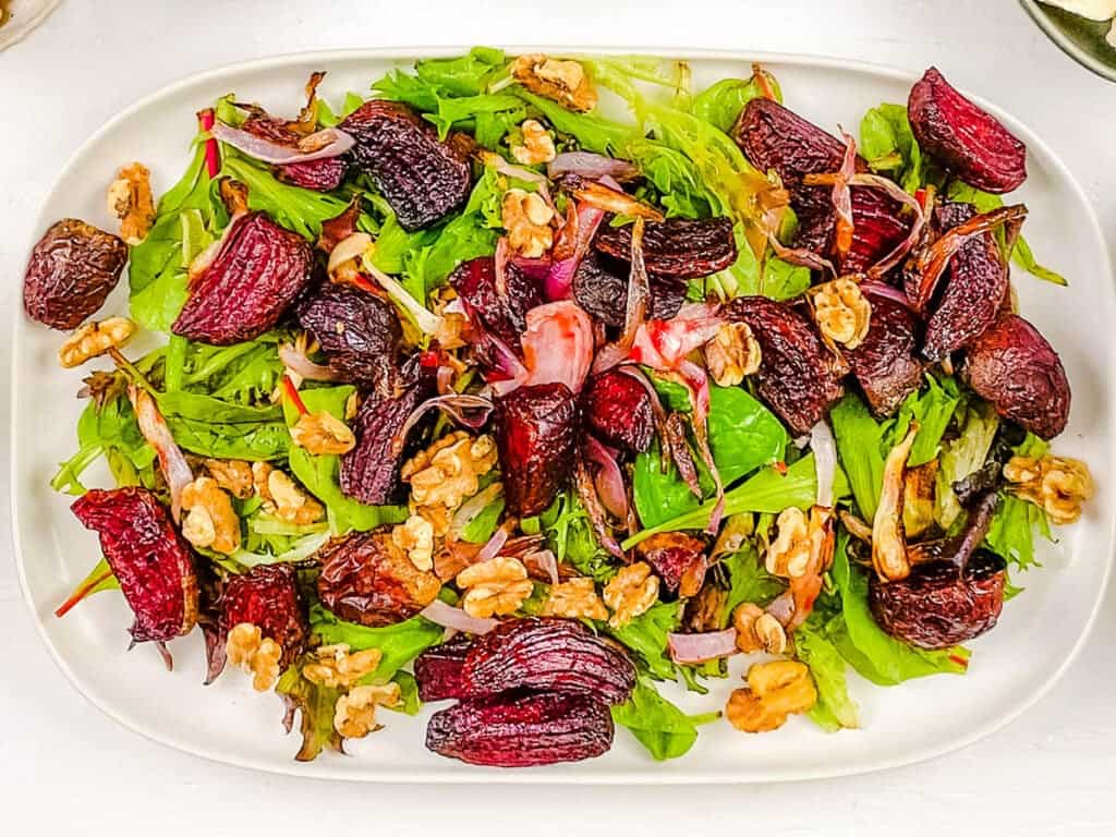 Feta walnut beetroot salad served on a white plate.