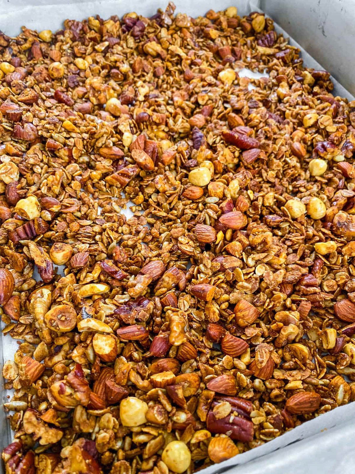 A closeup of healthy protein granola on a baking sheet.