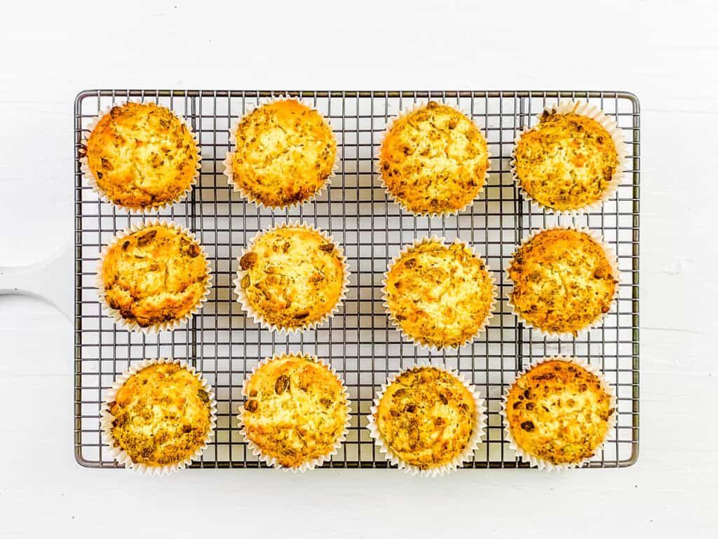 Easy pistachio muffins cooling on a wire rack.