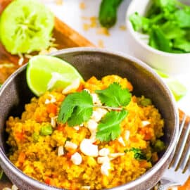 Indian masala oats served in a bowl, garnished with cilantro and lime.
