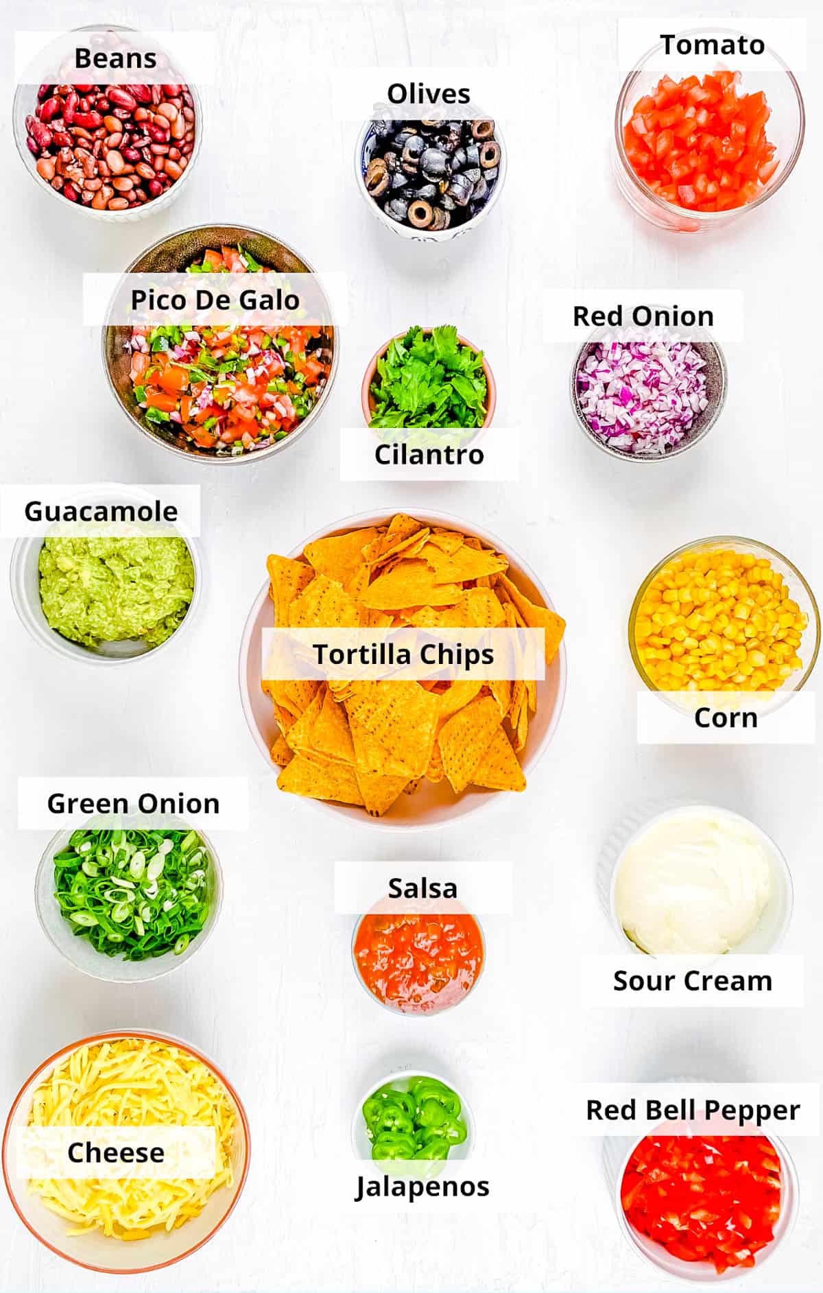Ingredients for easy healthy loaded veggie nachos recipe on a white background.