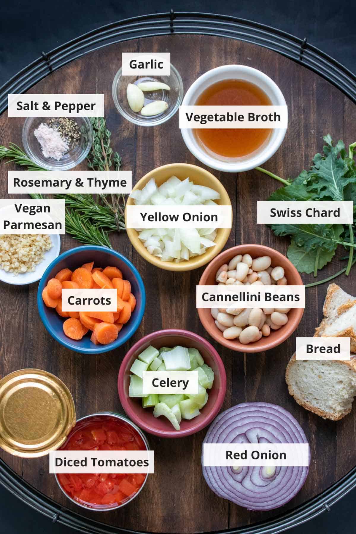 Ingredients for Tuscan ribolita soup recipe on a wood background.