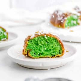 Vietnamese pandan honeycomb cake cut to show green pandan inside, served on a white plate.