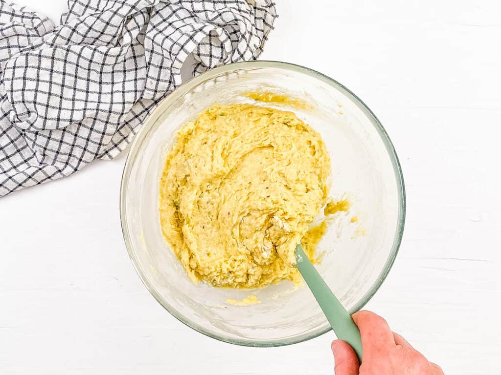 Muffin batter being mixed in a mixing bowl.