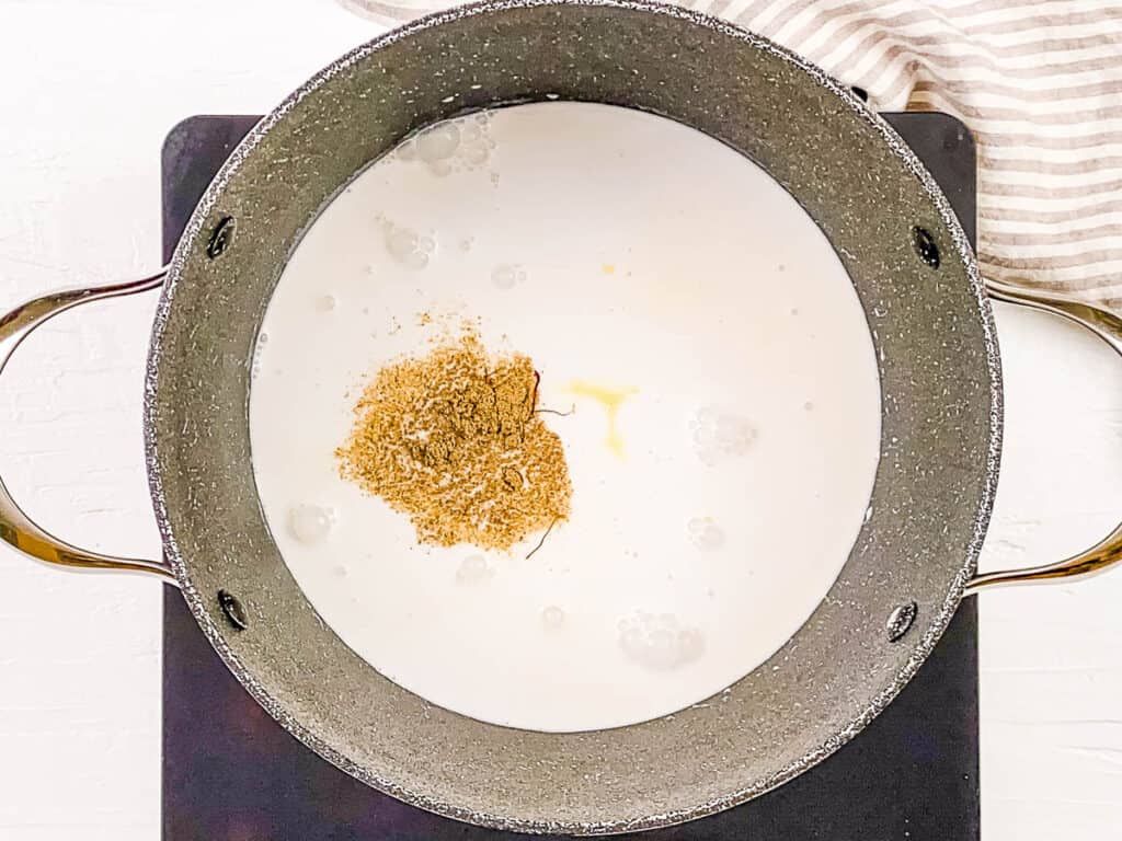 3 milk mixture being cooked in a large pot on the stove.