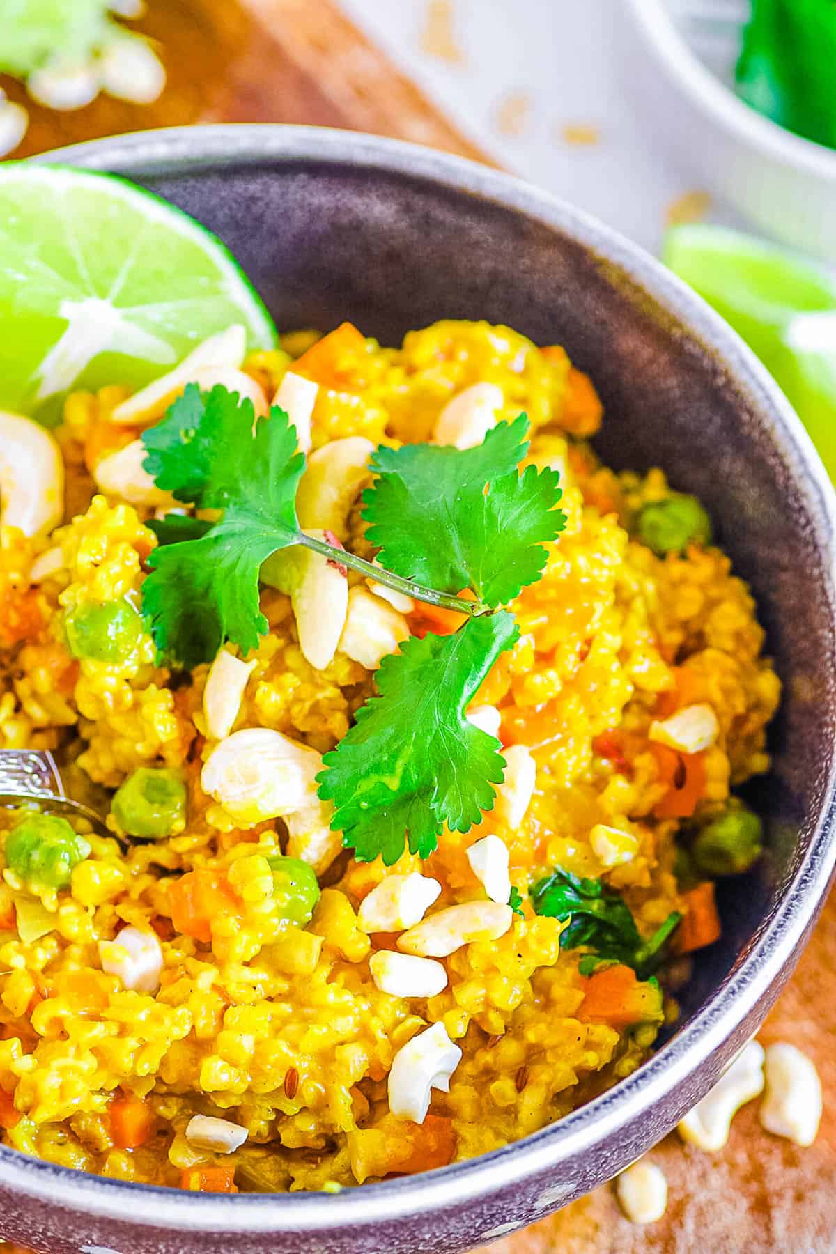 Easy healthy masala oats served in a bowl, garnished with cilantro and lime.