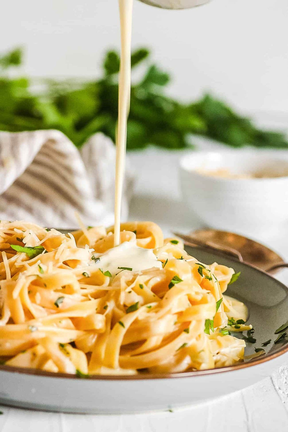Alfredo sauce without heavy cream poured over pasta on a plate.
