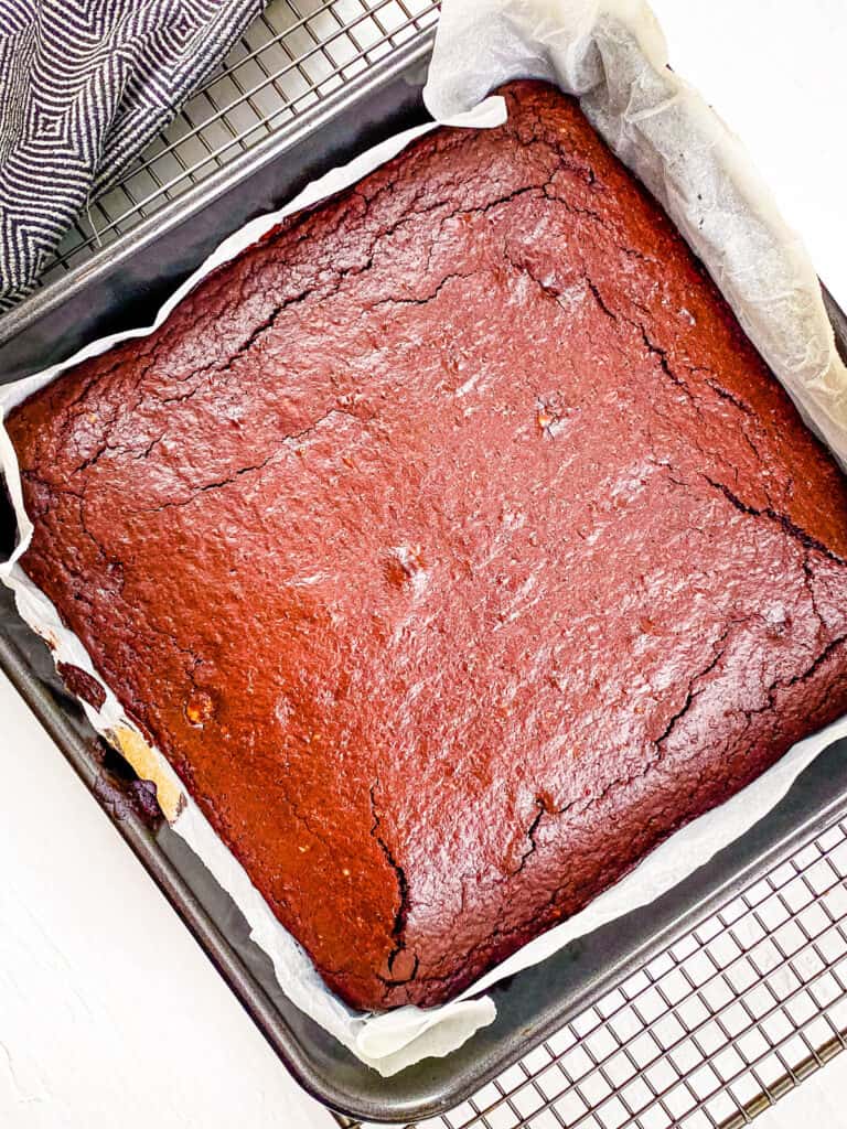 Emergency lactation brownies freshly baked, cooling in a baking dish on a wire rack.