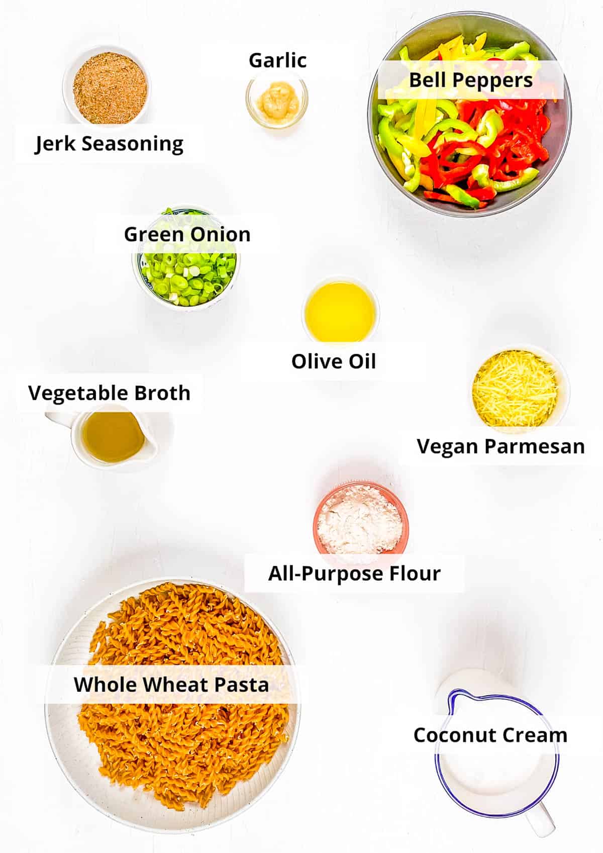 Ingredients for vegan rasta pasta recipe on a white background.