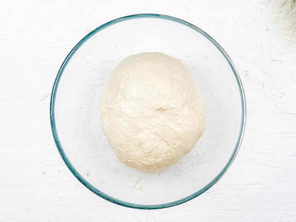 Poolish dough ball in a mixing bowl.