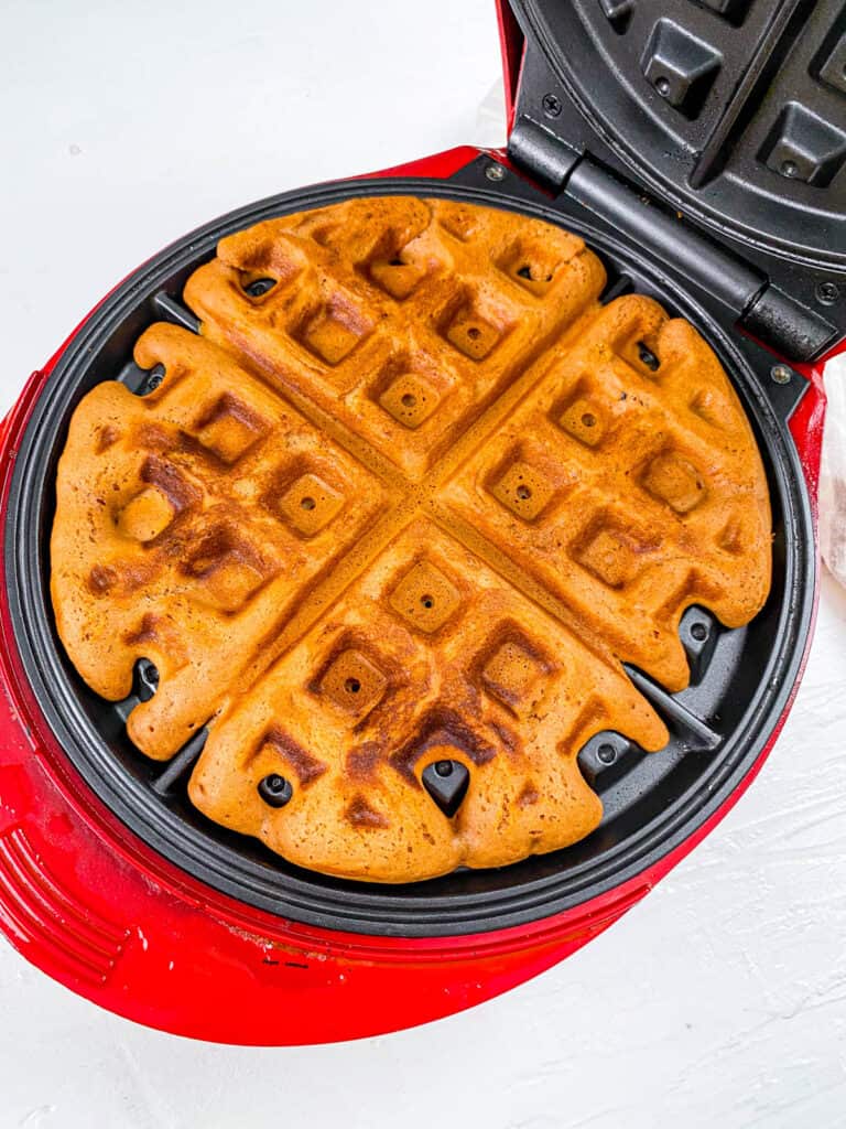 Nutella Belgian waffles cooking in a waffle iron.