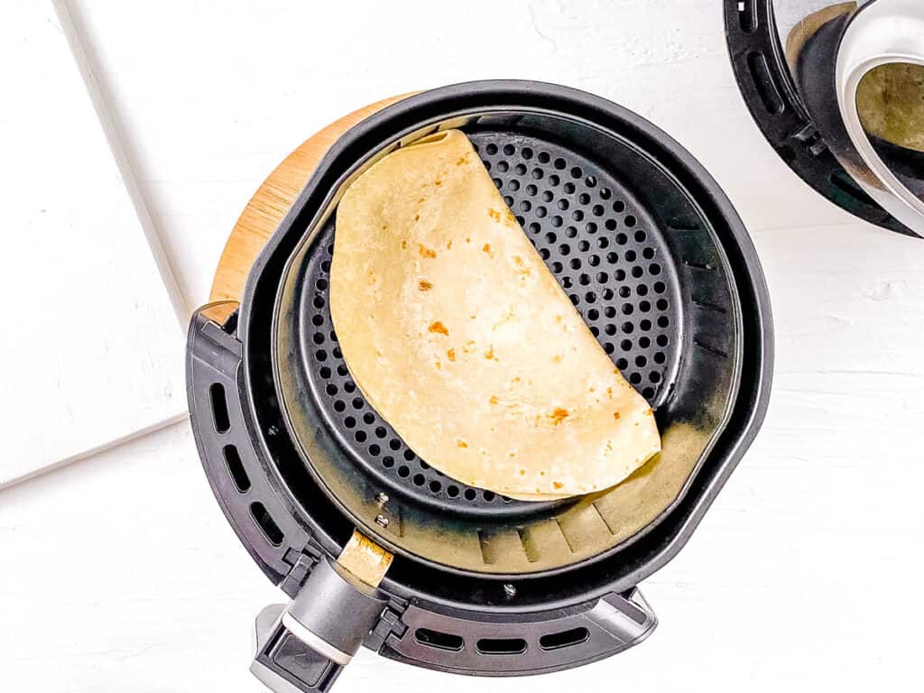 Easy air fried quesadillas being cooked in the air fryer.