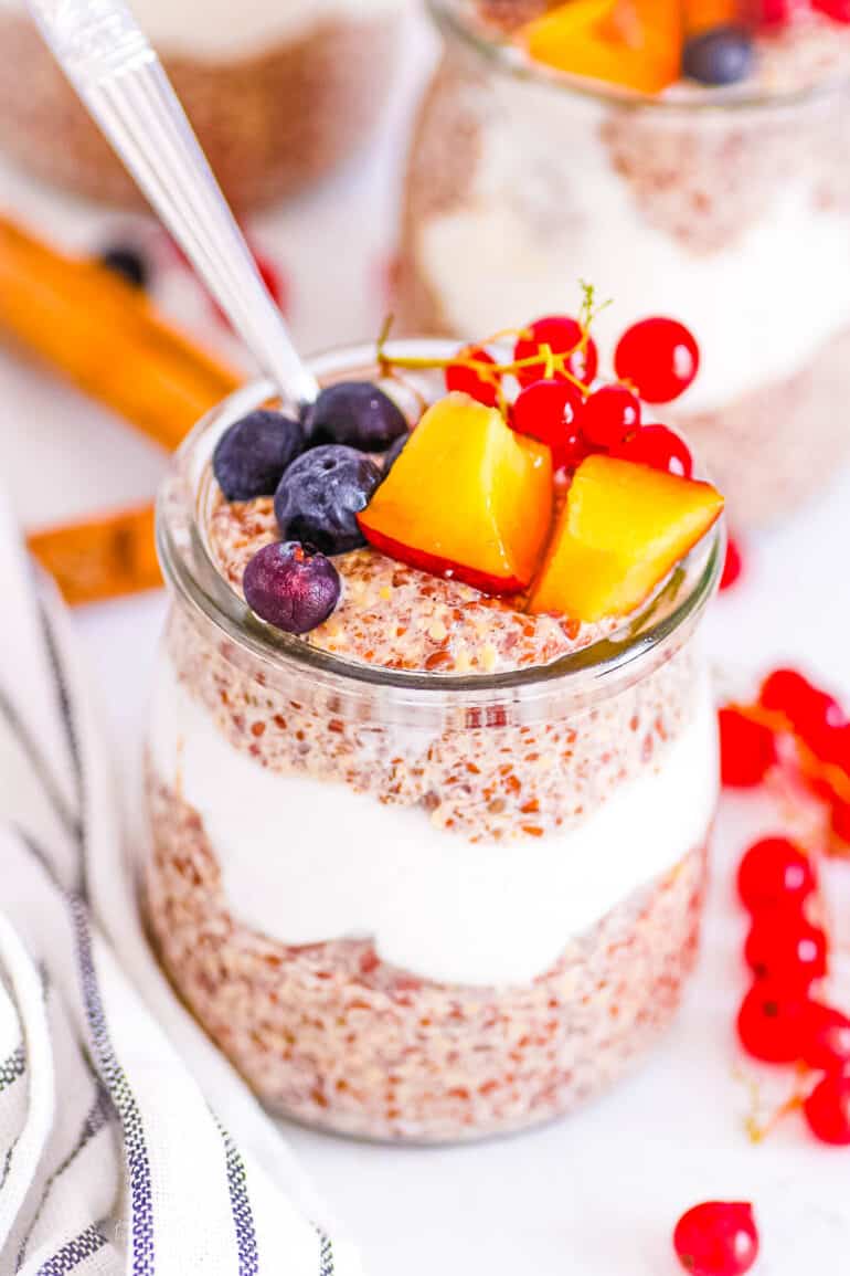 Healthy flaxseed pudding served in a glass jar topped with fresh fruit.