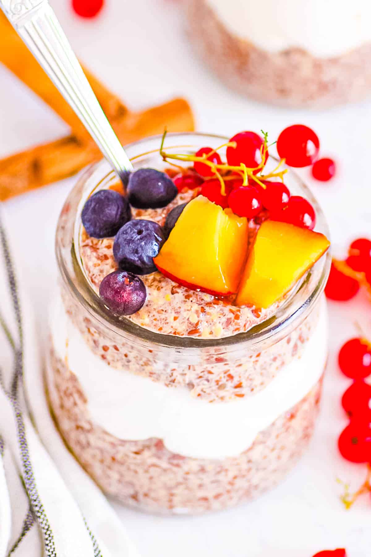 Easy flaxseed pudding served in a glass jar topped with fresh fruit.