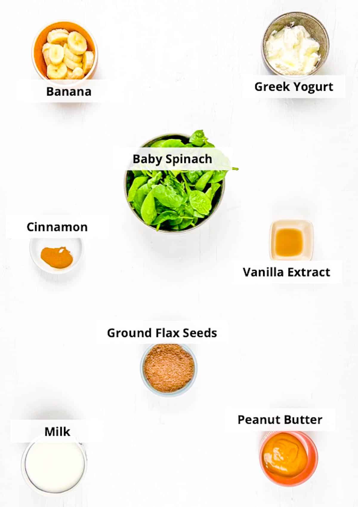 Ingredients for spinach and banana smoothie recipe on a white background.