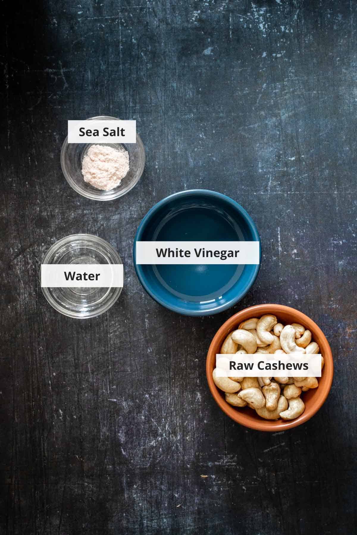 Ingredients for vegan queso fresco recipe on a black background.