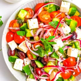 Keto Greek salad with feta served in a white bowl.