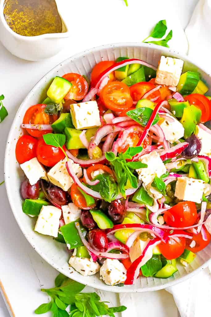 Keto Greek salad with feta served in a white bowl.