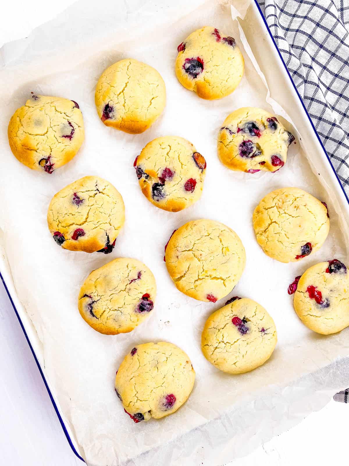 Lemon berry cookies on a baking sheet lined with parchment paper.