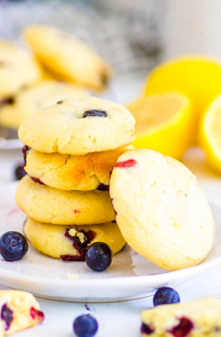 Lemon blueberry cookies stacked on a white plate.