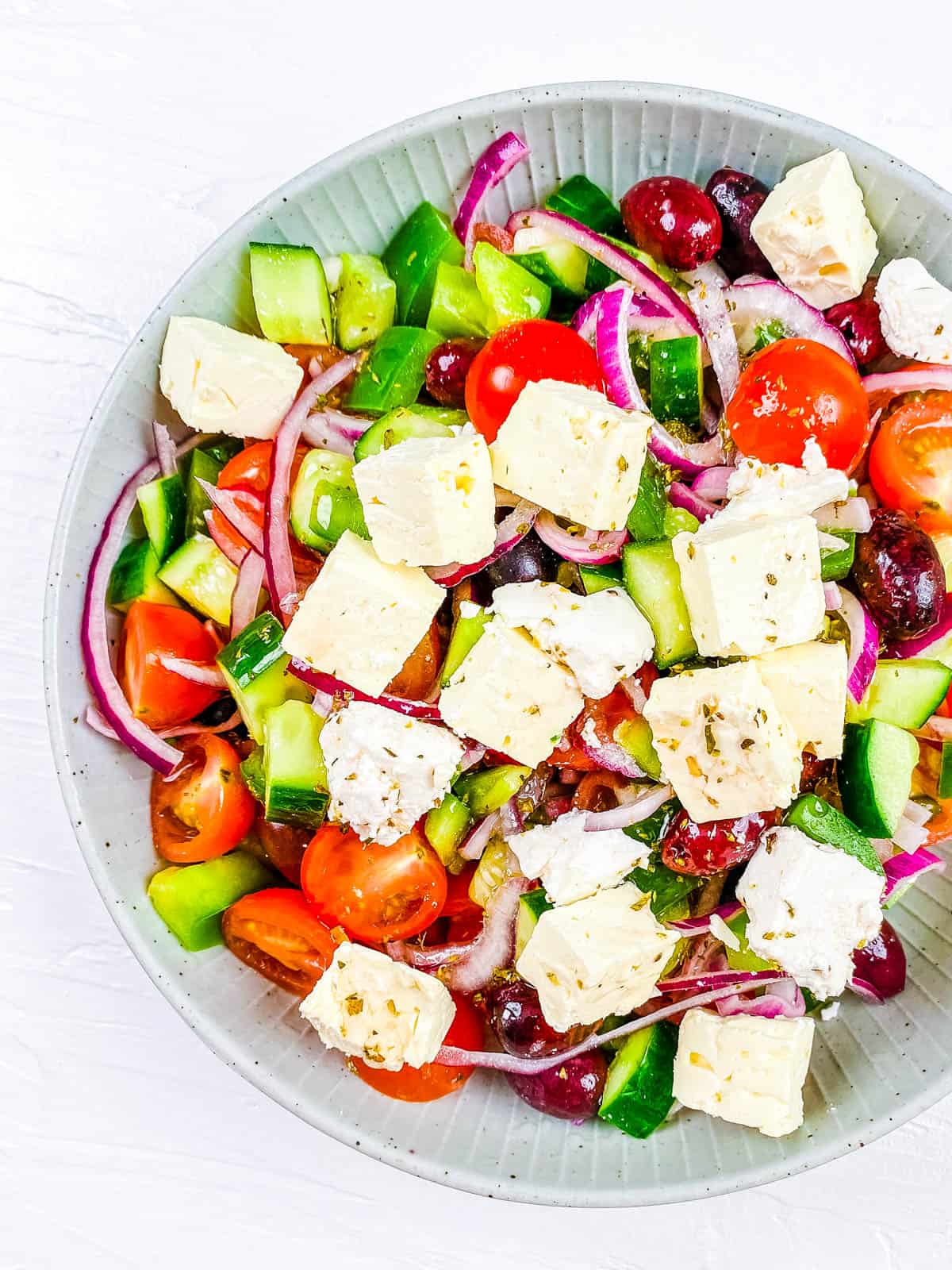 Low carb Greek salad in a white bowl.
