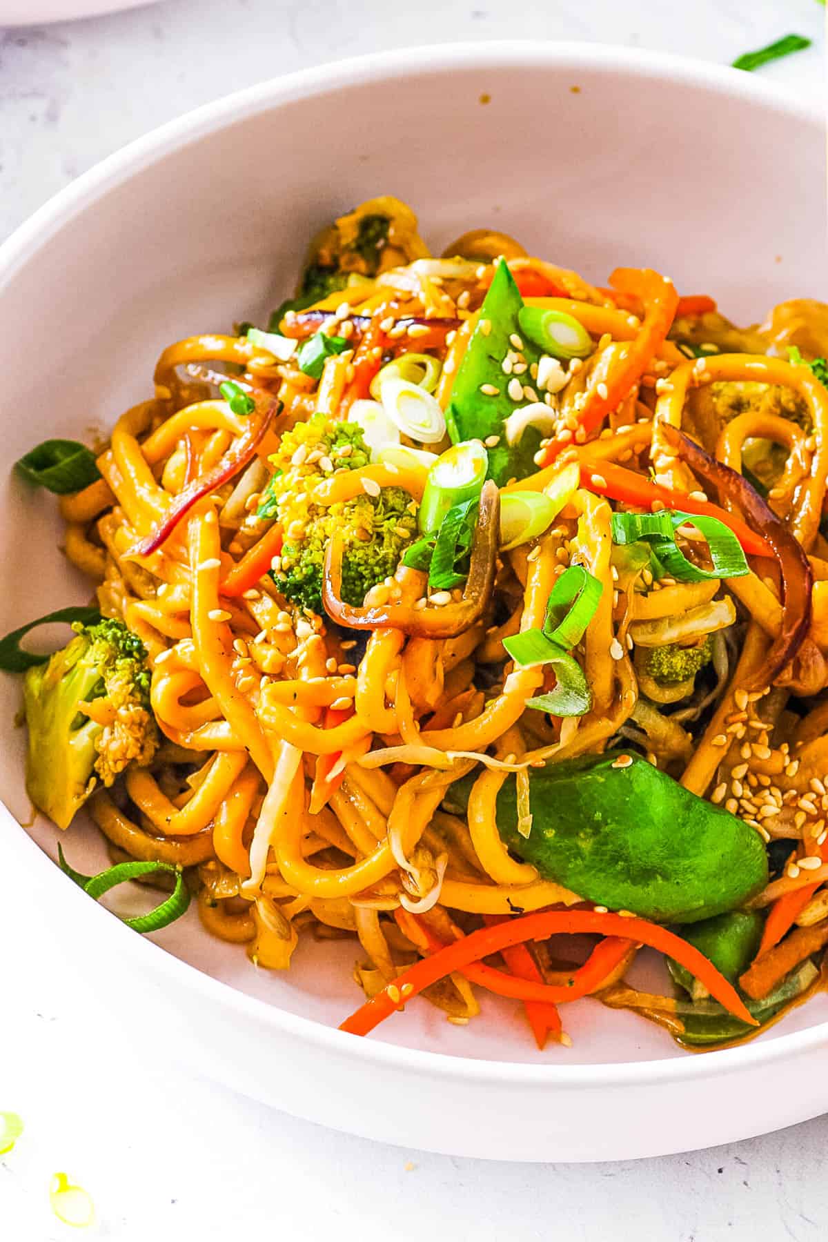 Easy vegan chow mein served in a white bowl with chopsticks.