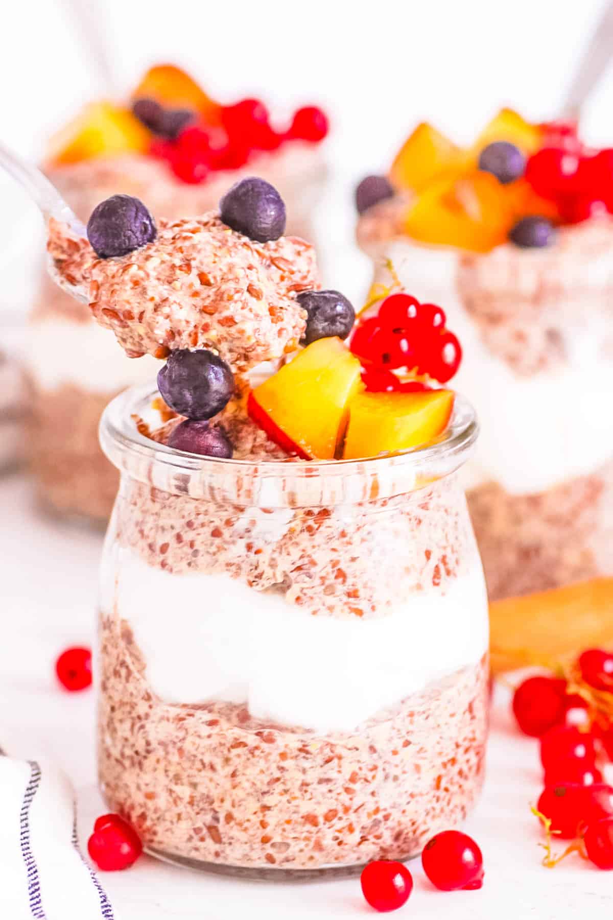 Gluten free vegan flaxseed pudding served in a glass jar topped with fresh fruit.