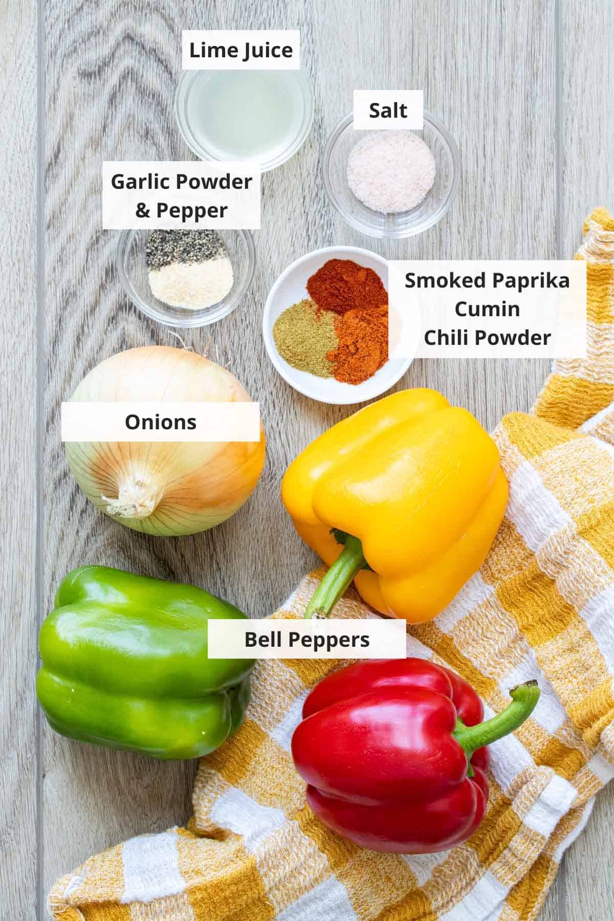 Ingredients for Chipotle fajita veggies on a wood background.