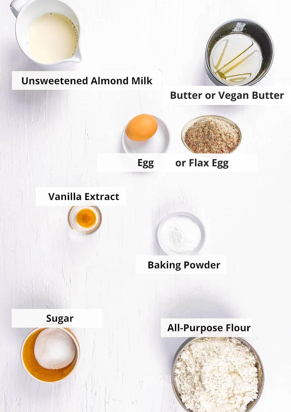 Ingredients for almond milk pancakes recipe on a white background.