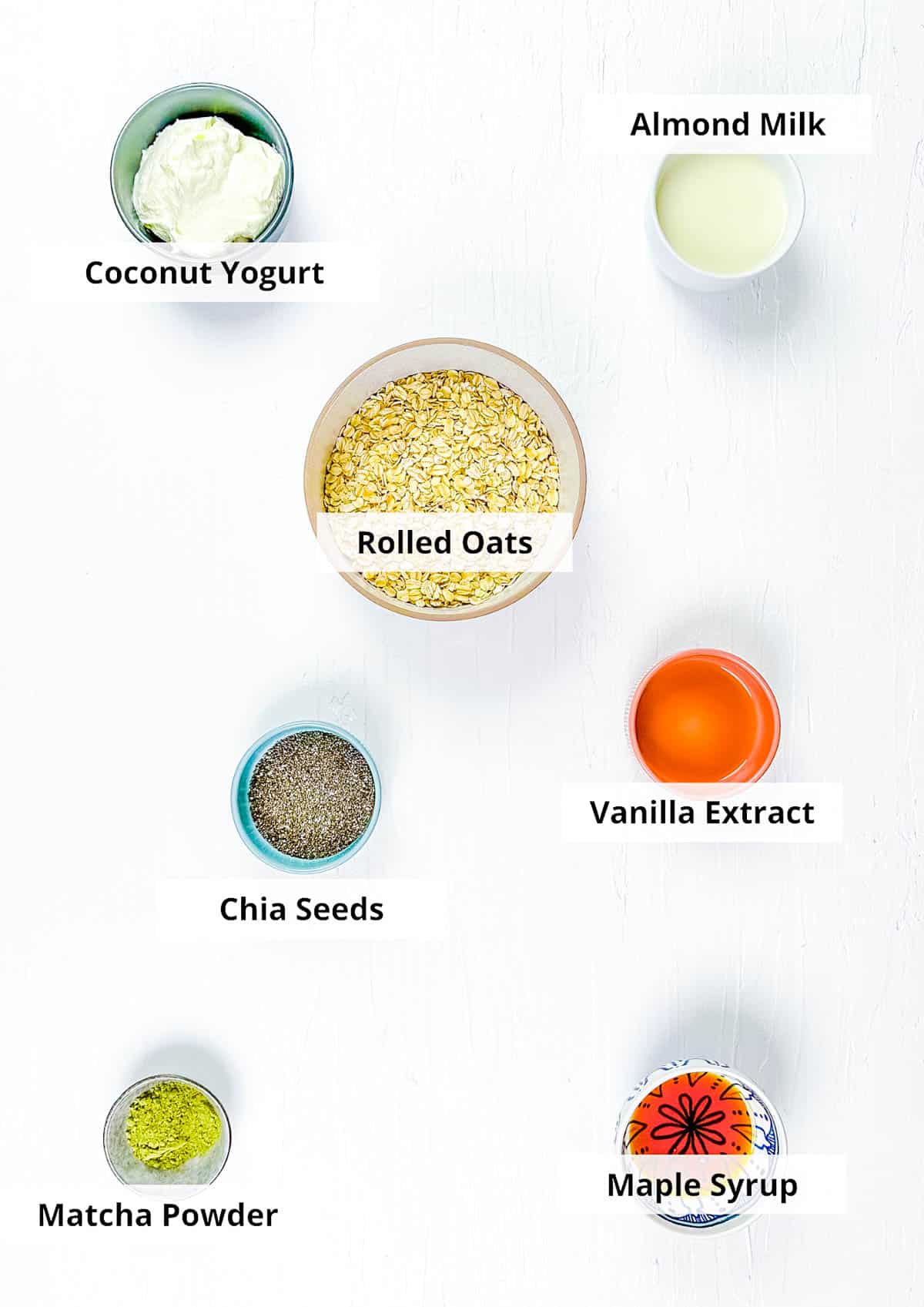 Ingredients for matcha overnight oats recipe on a white background.