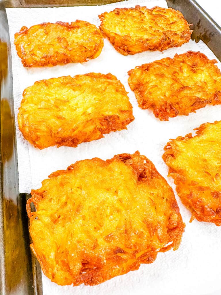 Copycat ،memade McDonald's hash browns draining on a paper towel after being pan fried.