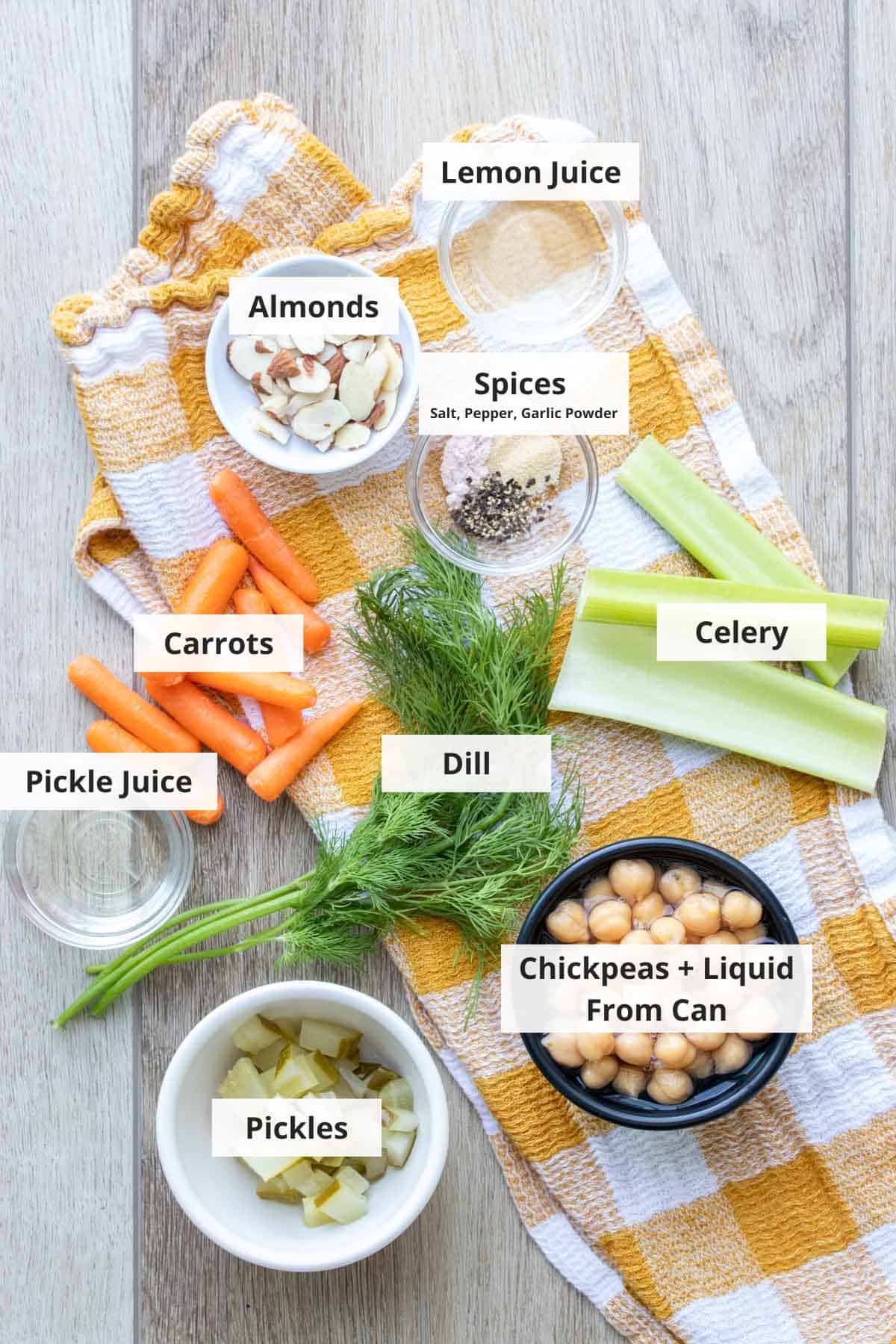 Ingredients for smashed chickpea salad sandwich recipe on a countertop. 