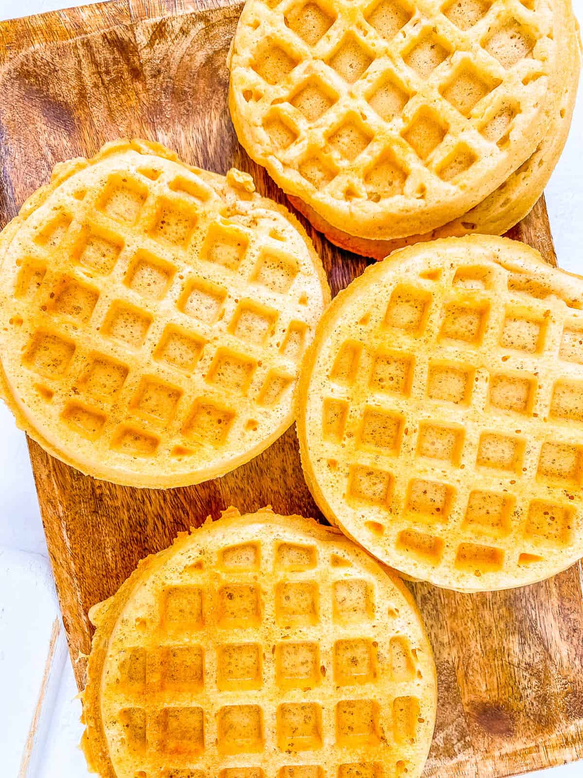 Healthy gluten free egg free waffles on a wooden cutting board.