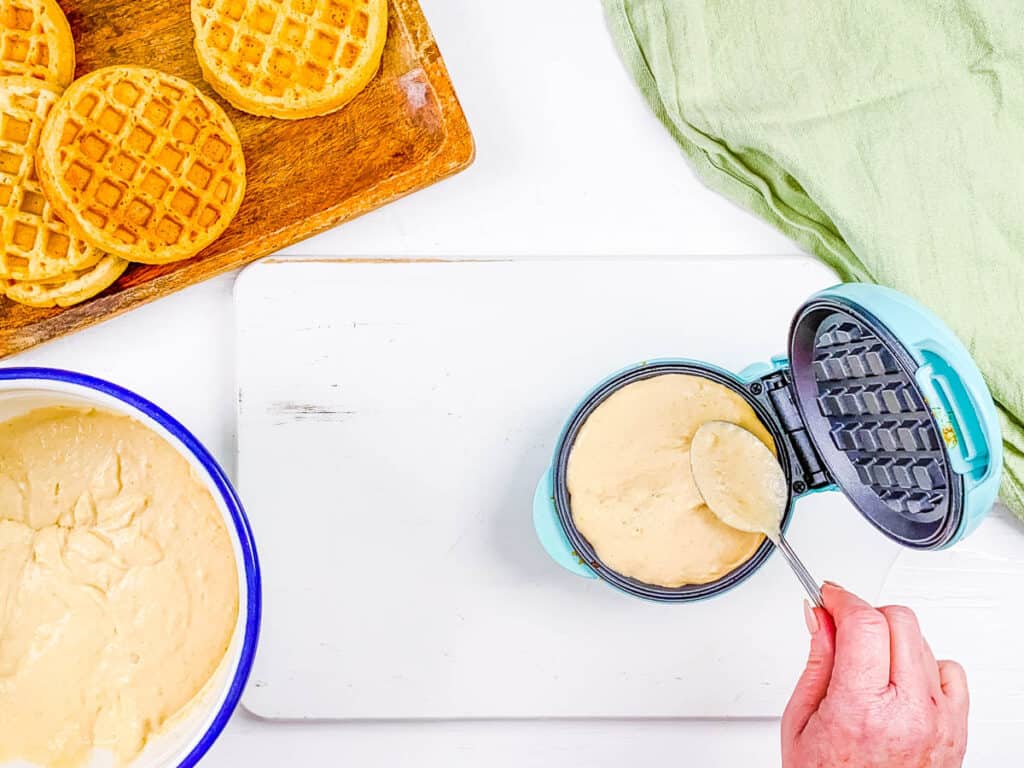 Healthy gf waffle batter added to a waffle iron.