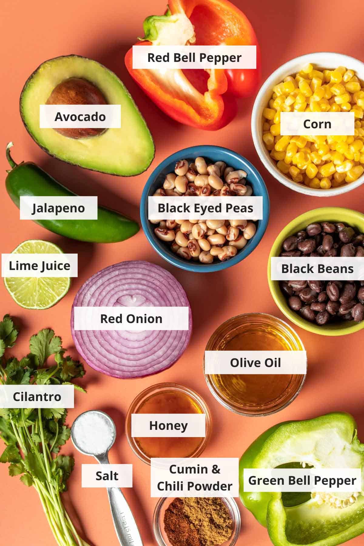 Ingredients for cowboy salad recipe on an orange background.