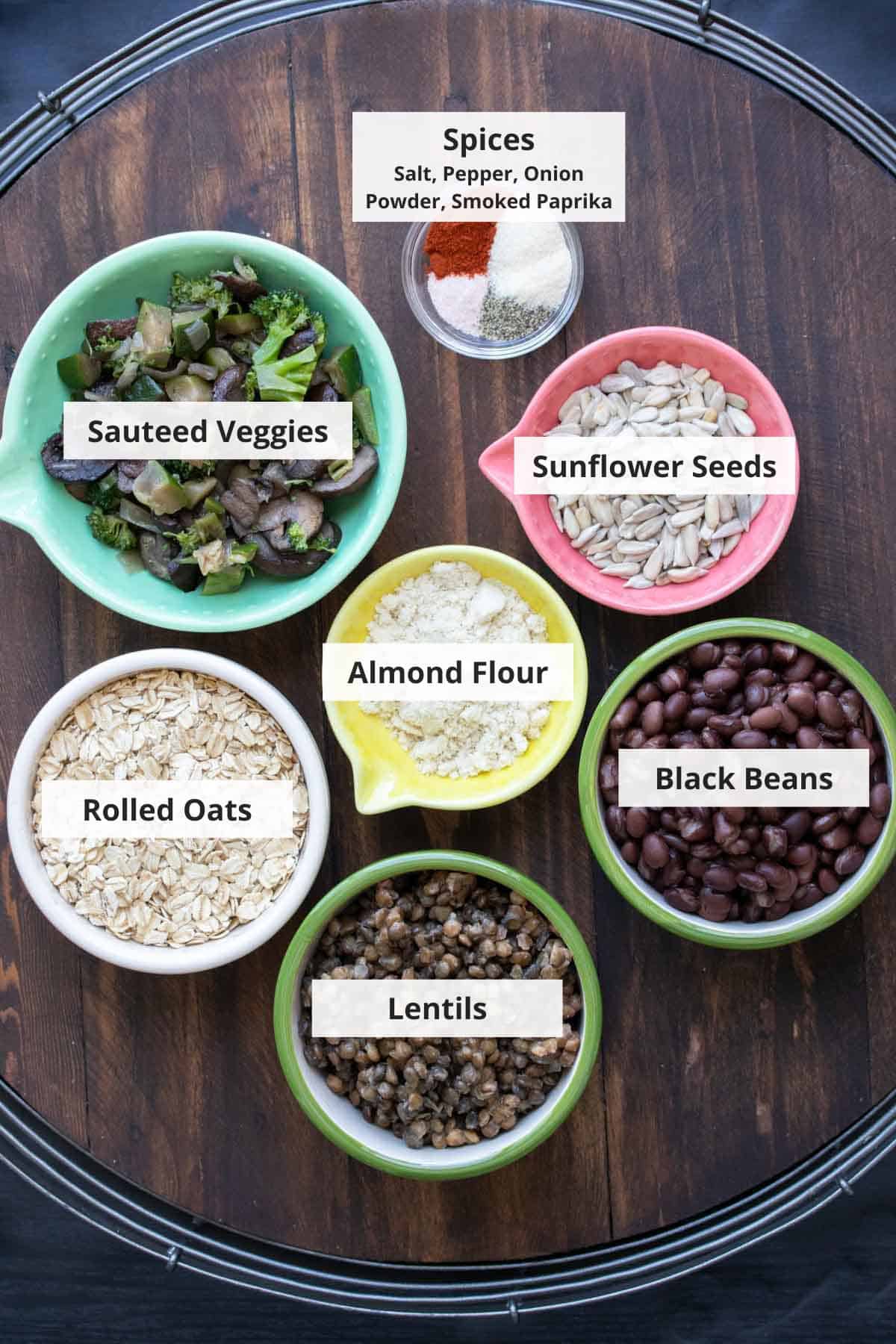 Ingredients for vegan lentil veggie burger recipe on a wood background.