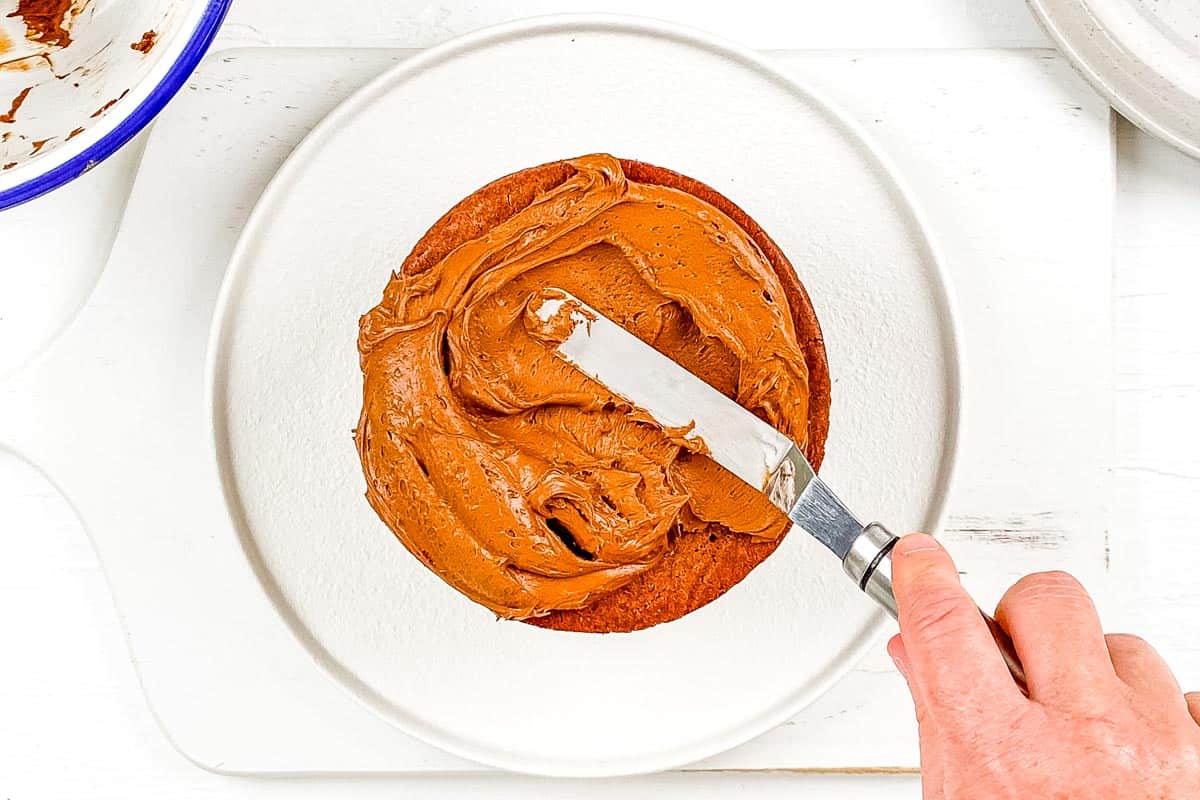 Decorating the cake with frosting, on a white background. 