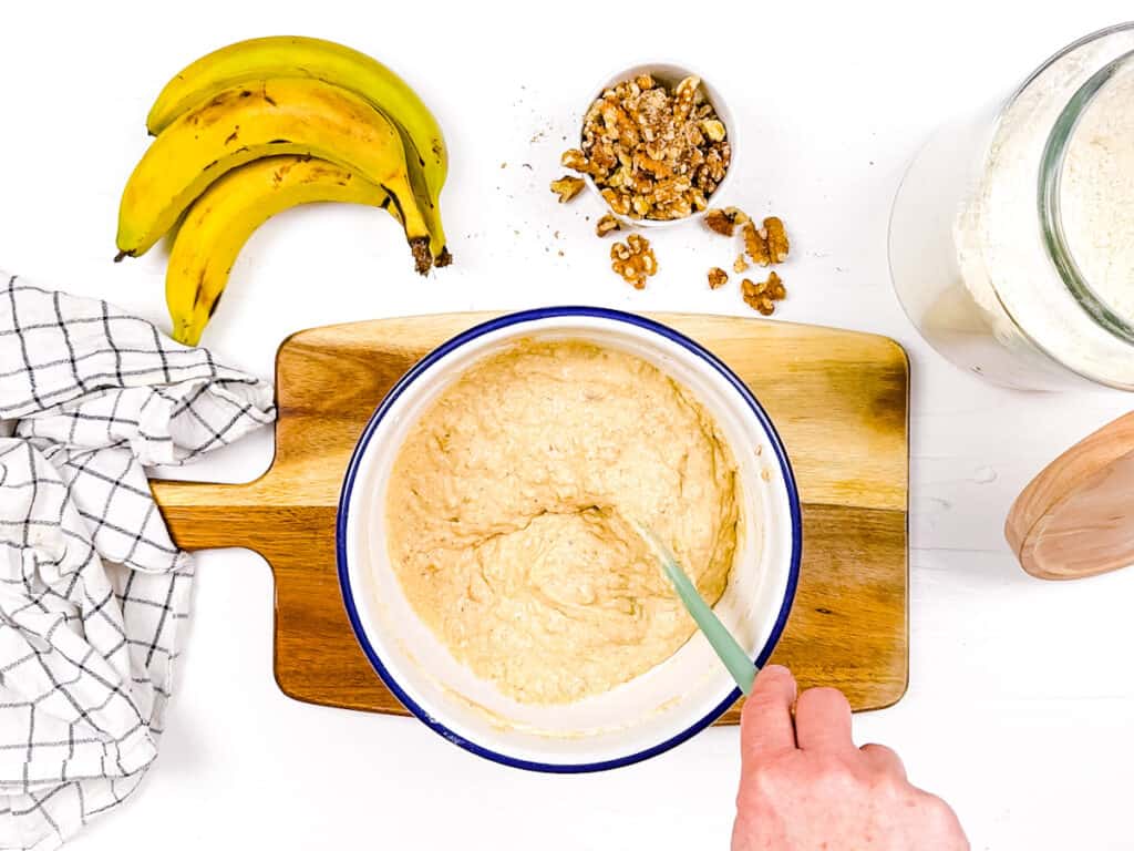 Healthy banana bread batter without butter mixed in a mixing bowl.