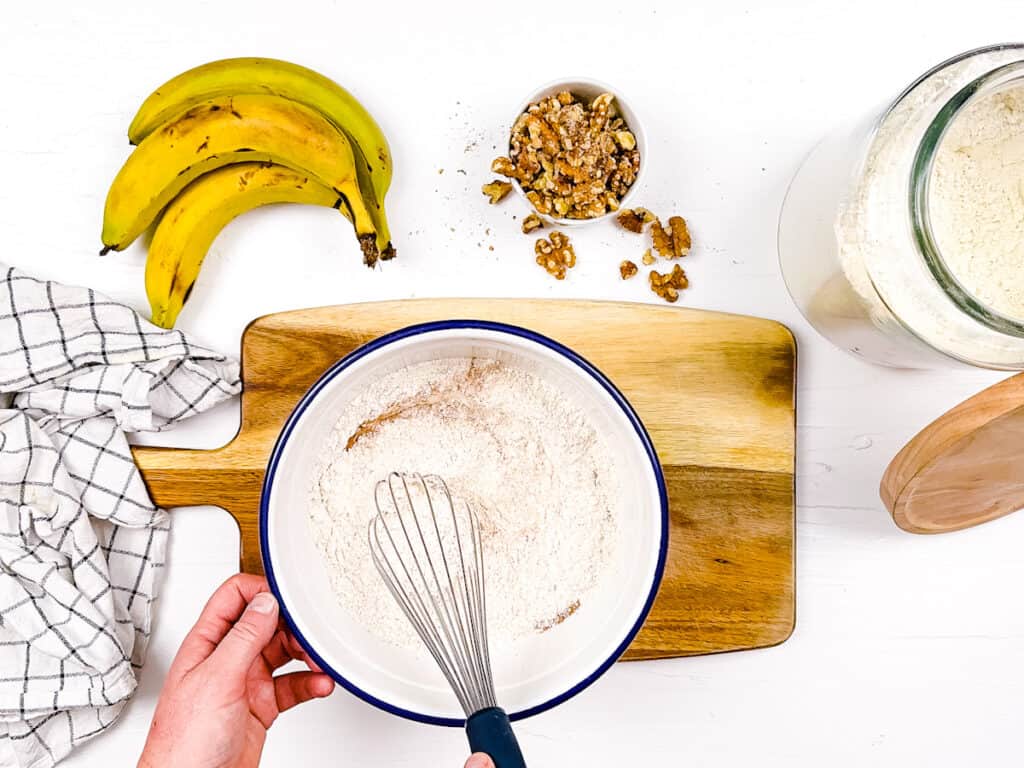 Quick bread dry ingredients whisked together in a mixing bowl.